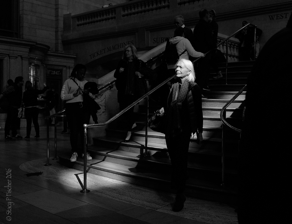 Shaft of sunlight highlights woman's face at Grand Central Station, NYC